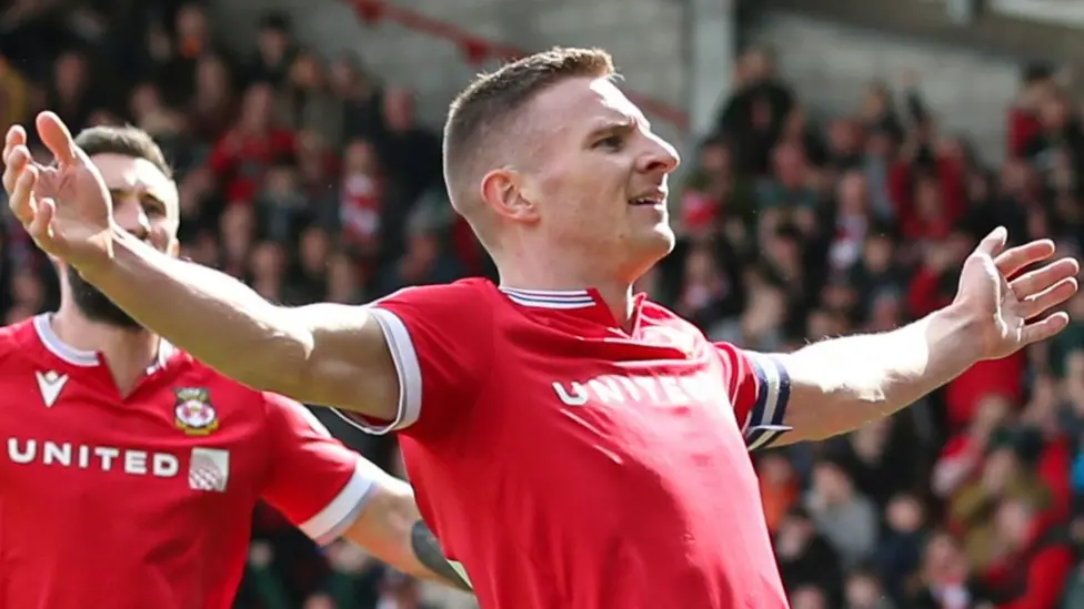 Paul Mullin has been Wrexham's leading scorer in both of their recent promotion seasons - but is now unable to make the matchday squad