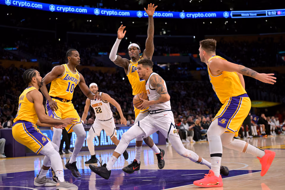 os Angeles, California, USA; Los Angeles Lakers center Christian Koloko (10), guard Gabe Vincent (7), forward Jarred Vanderbilt (2) and guard Luka Doncic (77) defend a drive by Denver Nuggets forward Michael Porter Jr.