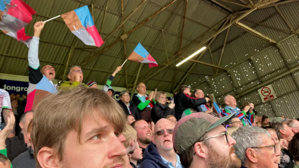 Harlequins supporters celebrate their team's only try in a 40-7 defeat by Leicester at Welford Road