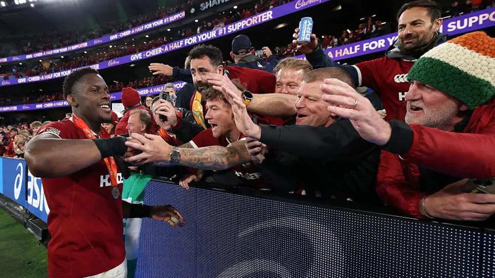Maro Itoje celebrates with Lions fans after clinching the series with victory over Australia in the second Test in Melbourne