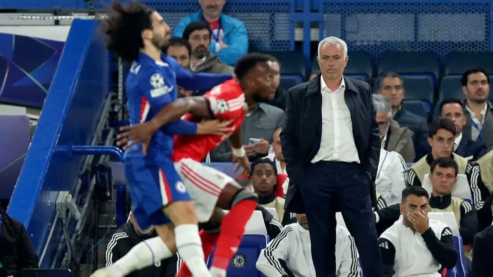 Benfica manager Jose Mourinho watches on as Chelsea defender Marc Cucurella challenges Dodi Lukebakio at Stamford Bridge