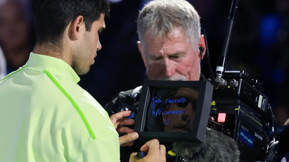 Carlos Alcaraz celebrated victory in the now traditional fashion by writing a post-match message on a TV camera lens to mark his history-making victory in Melbourne