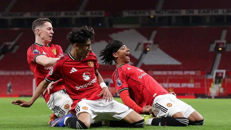 JJ Gabriel (centre) celebrates Junior Brown's (right) match winner with Jay McEvoy for Manchester United in the FA Youth Cup against Sunderland at Old Trafford