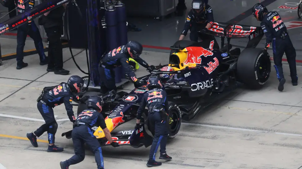Verstappen's Red Bull is pushed into the garage by team mechanics as he retires from the Chinese Grand Prix